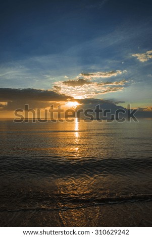 Beautiful view of the sunset, sea, waves, sand and beach