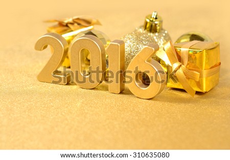 2016 year golden figures on the background of golden Christmas decorations