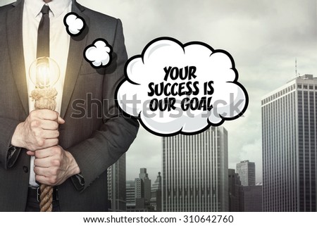 Your succes is our goal text on speech bubble with businessman holding lamp on city background