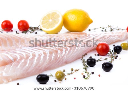 uncooked raw fillet  of cod with serving spices on white background