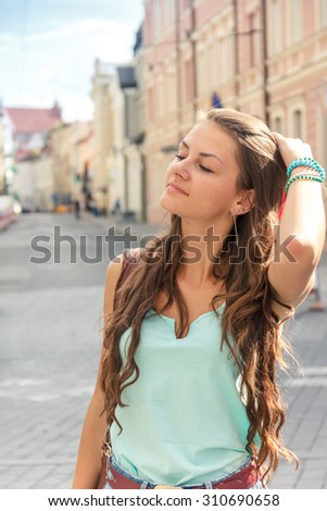 beautiful girl on the background of old houses