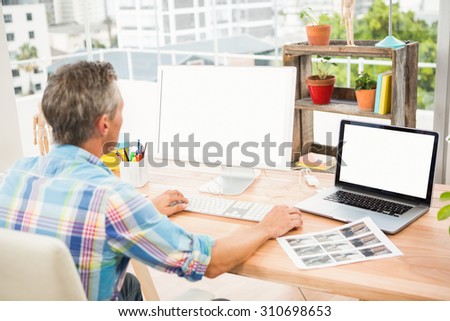 Casual designer working on computer in the office