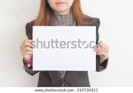 young girl holds a cardboard sign Royalty-Free Stock Photo #310730351