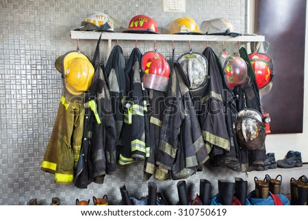 Firefighter's uniforms and gear arranged at fire station Royalty-Free Stock Photo #310750619