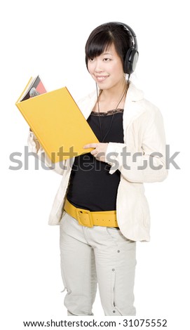 Asian woman standing and holding yellow book and listening music headphones