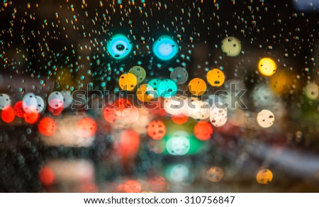 Defocused blur of light on the road in a raining day