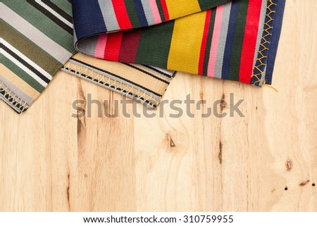 Tibet fabric on the wood background.