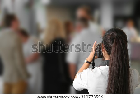 Wedding photographer taking photographs of wedding 