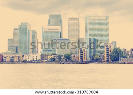 RETRO PHOTO FILTER EFFECT: Canary Wharf, London from the South side of the River Thames, London, England, UK.