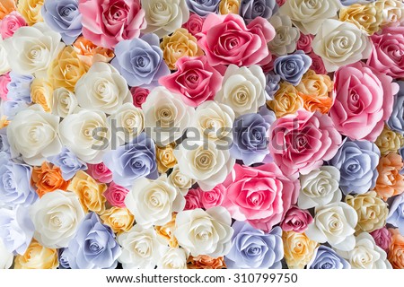Backdrop of colorful paper roses background in a wedding reception.