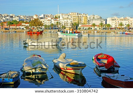Fishing boats in the historic Harbor of Lagos on a beautiful summers day, Lagos, The Algarve, Portugal Royalty-Free Stock Photo #310804742