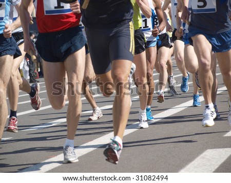Sporting events on the run. Athletes in sportswear and shoes Royalty-Free Stock Photo #31082494