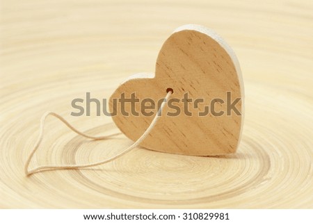 Heart shape symbol over texture of bamboo plate