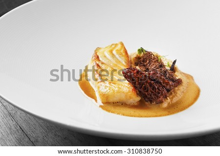 Roasted halibut with morels and potato puree Royalty-Free Stock Photo #310838750