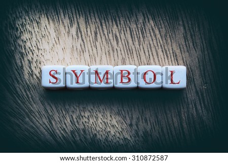SYMBOL word written on white cubes