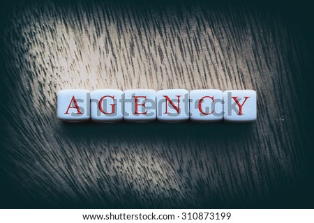 AGENCY word written on white cubes