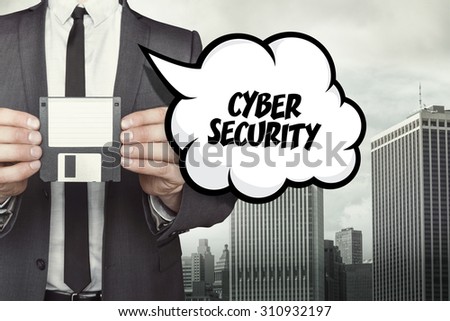 cyber security text on speech bubble with businessman holding diskette on cityscape background
