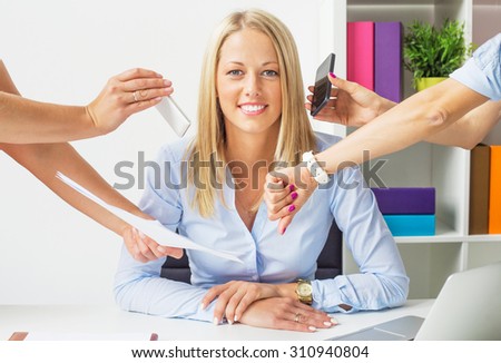 Stress free business woman in the office Royalty-Free Stock Photo #310940804