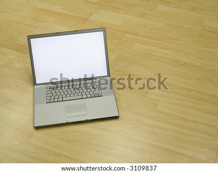 Landscape photo of a laptop on a pine wood floor