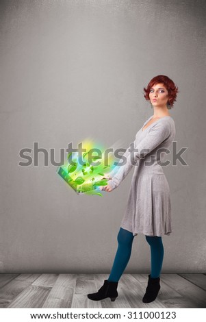 Casual young woman holding notebook with recycle and environmental symbols