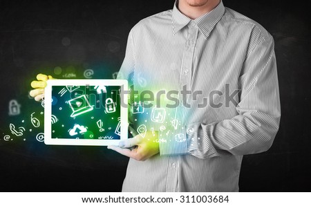 Person holding tablet pc with green media icons and symbols