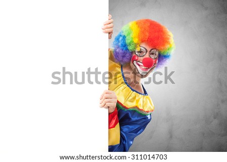 Smiling clown holding a blank panel