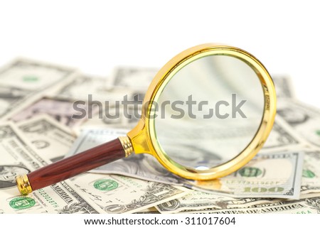 dollar banknotes under magnifying glass isolated