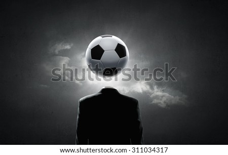 Unrecognizable man with soccer ball instead of head