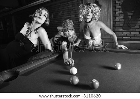 Three prime adult retro Caucasian females shooting pool.