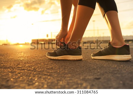 Female getting ready for a run early morning.  Royalty-Free Stock Photo #311084765