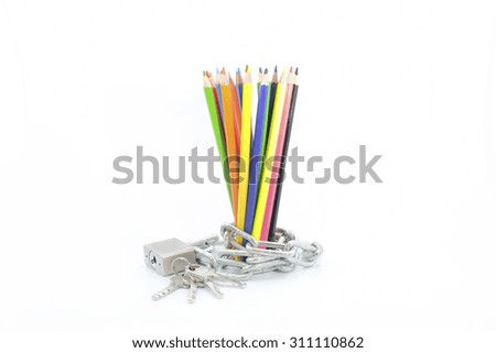 Colourful pencils isolated on white background close up chained with key