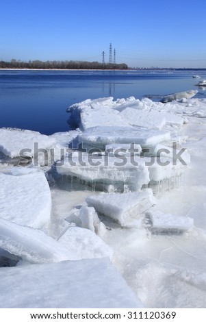 Landscape ice drift on the river in the early spring on a sunny day 