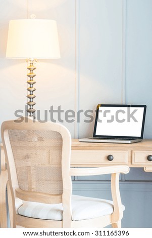 Laptop and light lamp on table