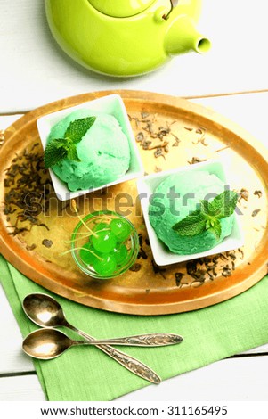 Homemade green tea ice-cream on light wooden background