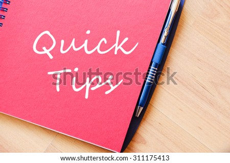 Notepad and pen on wooden background and text concept