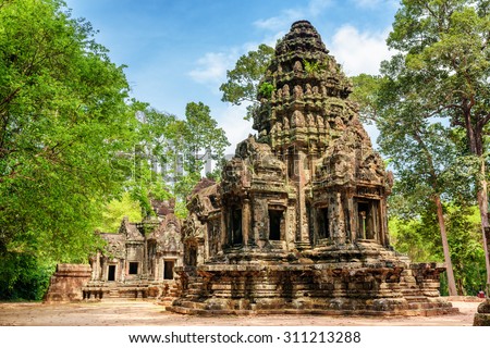 Main tower of ancient Thommanon temple in amazing Angkor, Siem Reap, Cambodia. Mysterious Thommanon nestled among rainforest. Blue sky in background. Enigmatic Angkor is a popular tourist attraction.