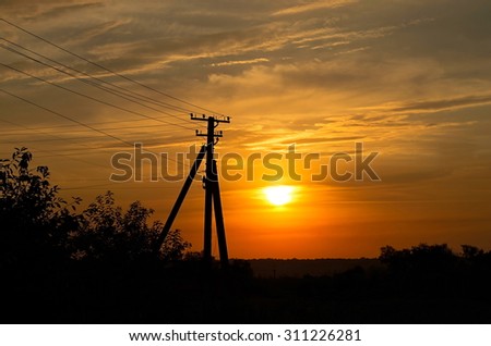 electric pole on the background of sunset