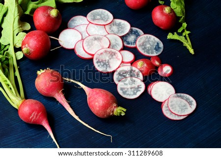 fresh red radish vegetables with green leaves - Stock image