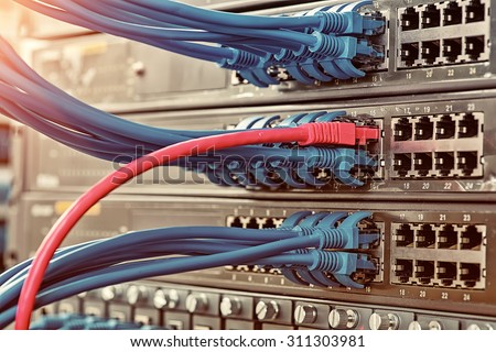Information Technology Computer Network, Telecommunication Ethernet Cables Connected to Internet Switch. Royalty-Free Stock Photo #311303981