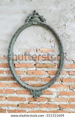 Vintage oval photo frame on brick wall