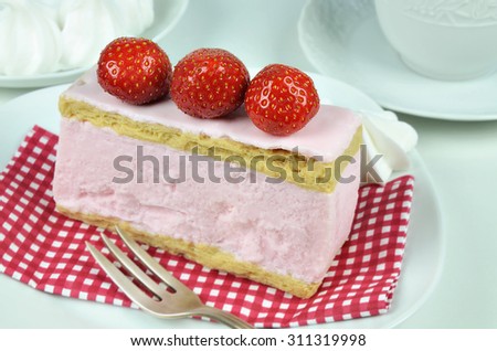  a portion of strawberry fancy cake with pastry fork on white plate, macro, horizontal /   Strawberry Fancy Cake 