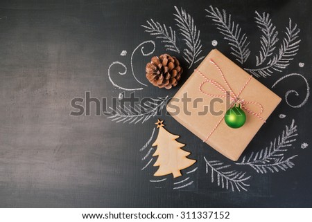 Christmas holiday gift on chalkboard background. View from above with copy space