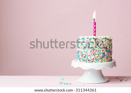Birthday cake with one candle Royalty-Free Stock Photo #311344361