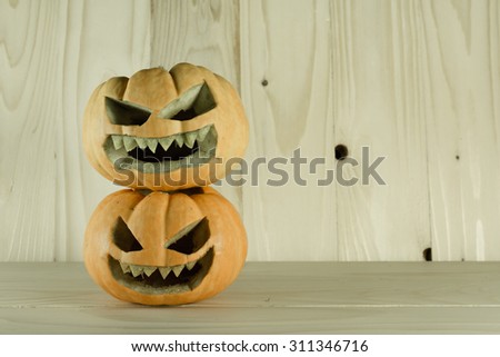 vintage color tone image of Halloween pumpkins with a Jack 'O Lantern on wooden background.