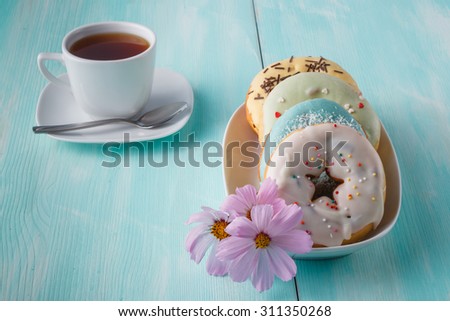 Four donuts on old wood table