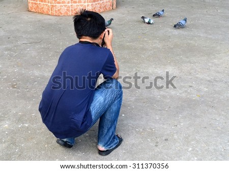 Photographer taking pigeon photo