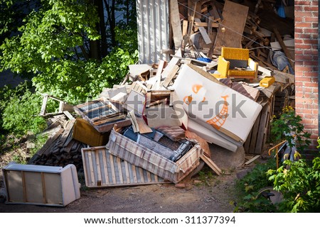 Funny broken furnitures trash pile Royalty-Free Stock Photo #311377394