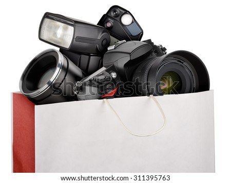 Shopping bag with photography equipment isolated on white background