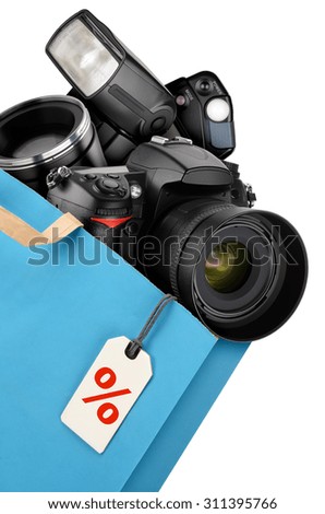 Shopping bag with photography equipment isolated on white background. Discount concept