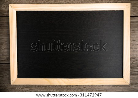 Blackboard on wooden background